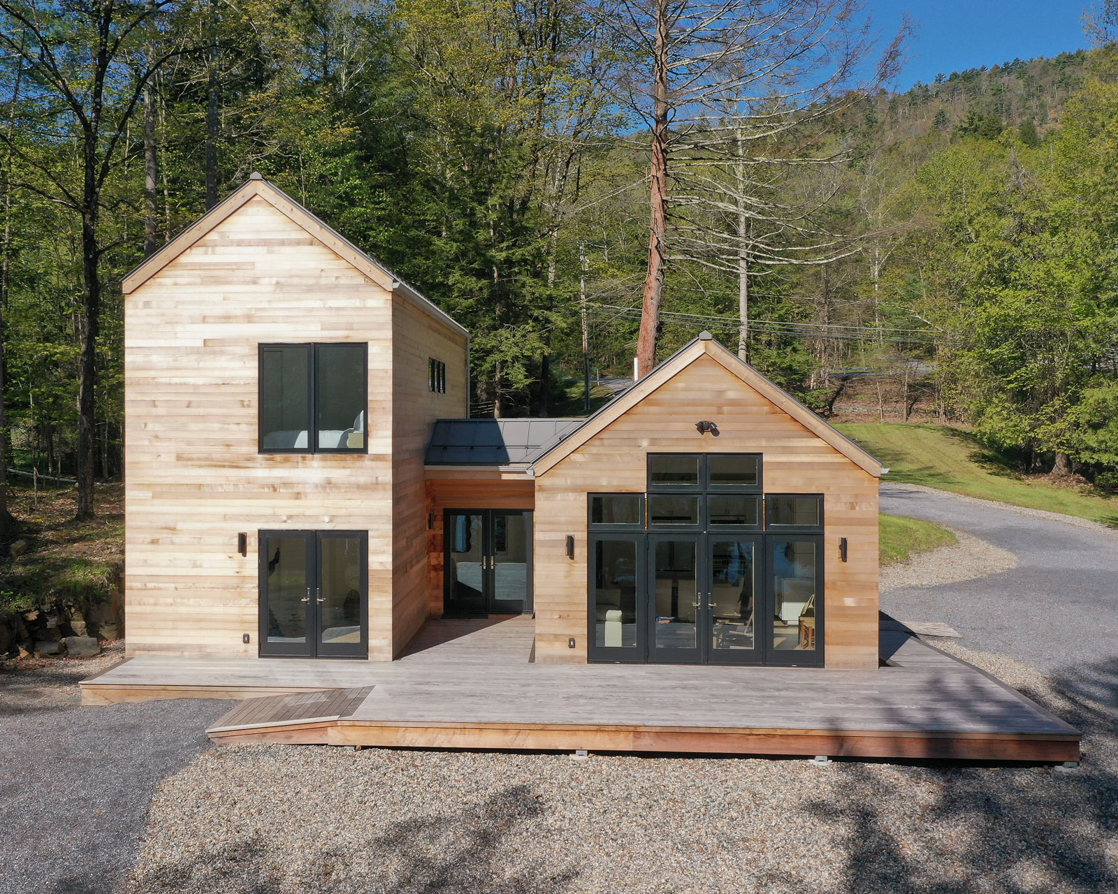 This Lake George guest cottage is sided with a western red cedar. It has a warm tone that glows with the reflection of light passing through the trees. As it ages it will turn to a stone grey that will reflect the colors of the bedrock that stretches through the earth.