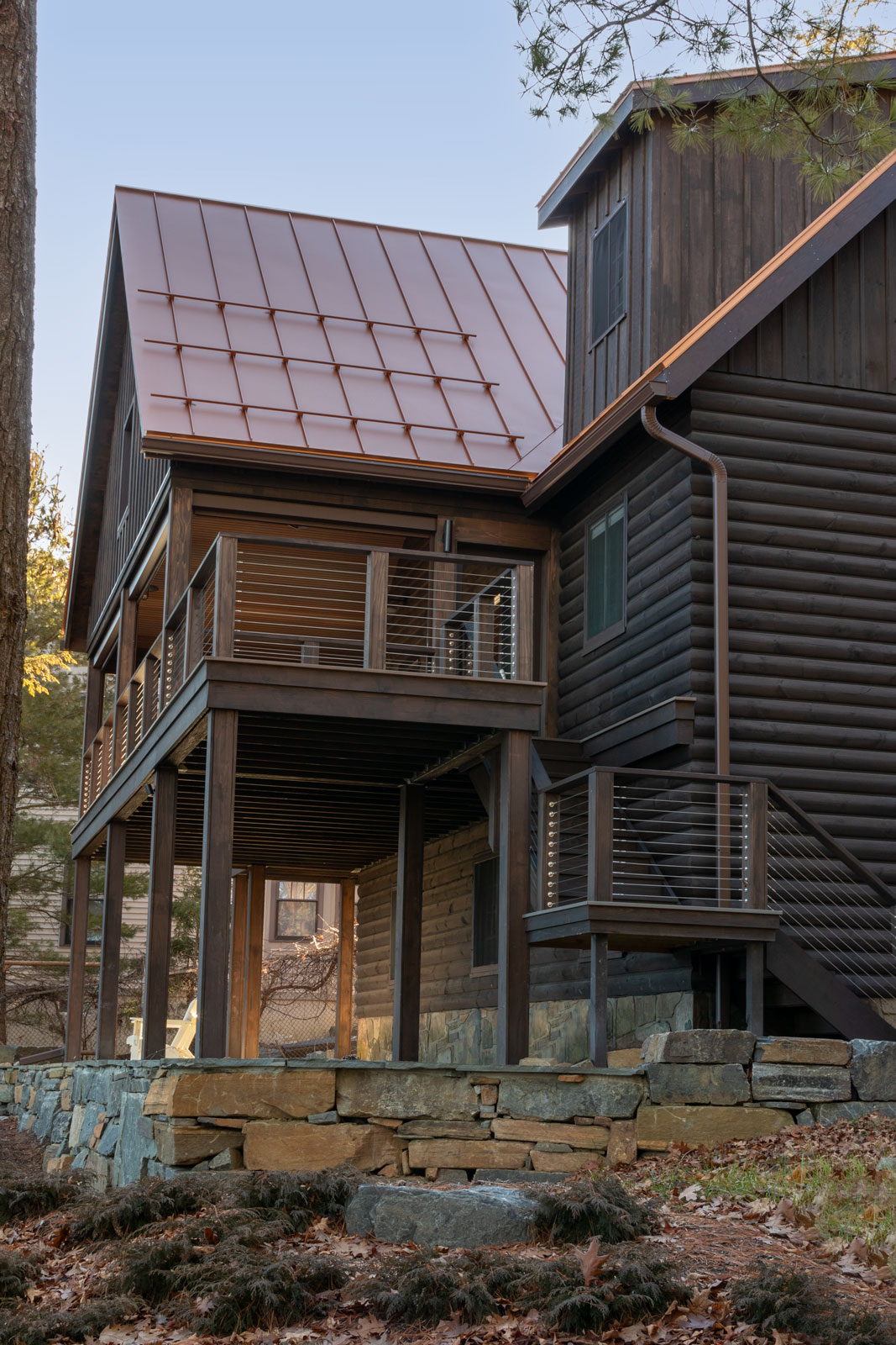 The attention to the details of the deck addition was paramount to success. The material selection for the design focused on harmonizing the colors and form of the existing cabin while selecting wood siding that blended with the natural surroundings of the shore.