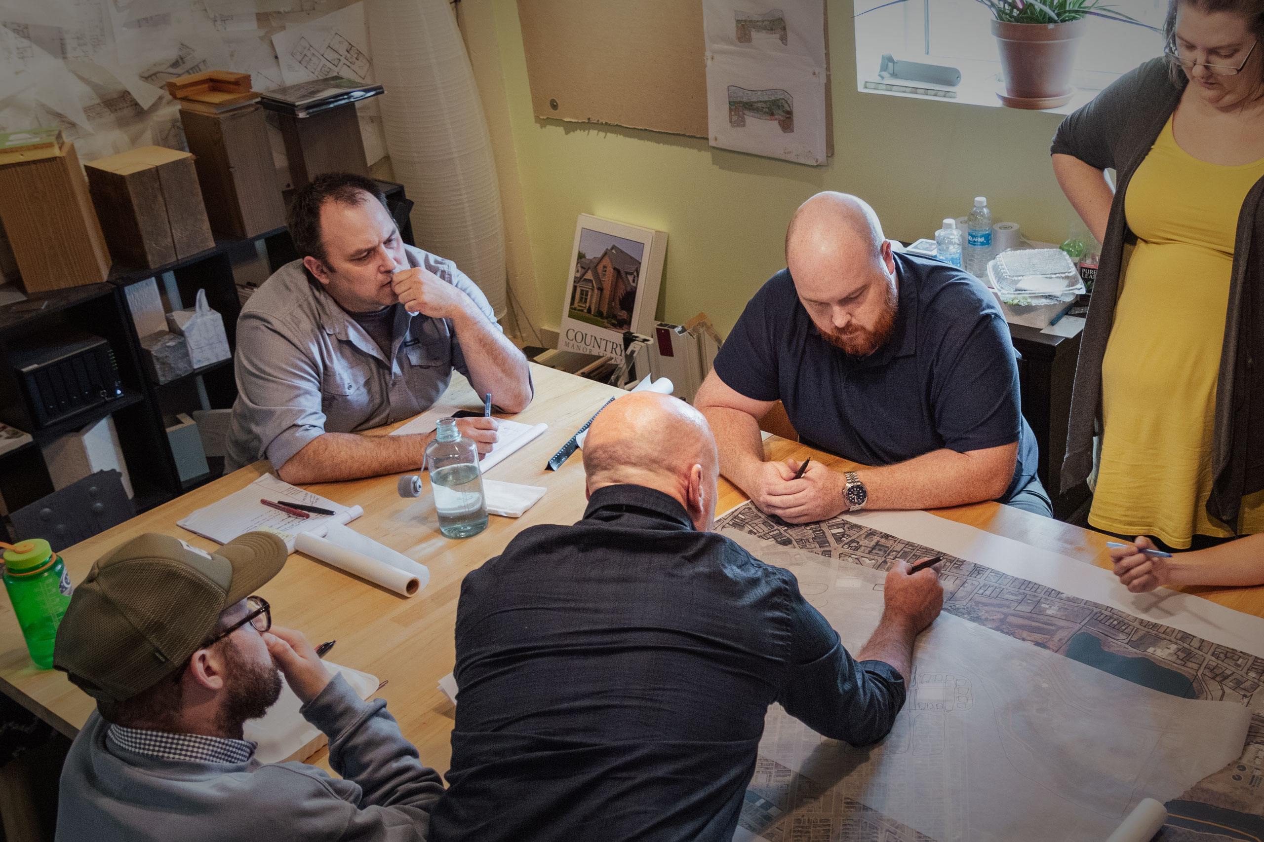 The AJA Architecture and Planning Team designing in the conference room.