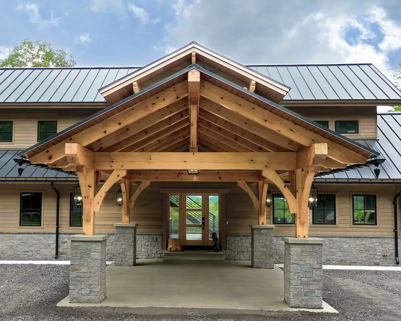 An Adirondack porte cochere entrance to a custom residential lodge near Gore Mountain ski resort.