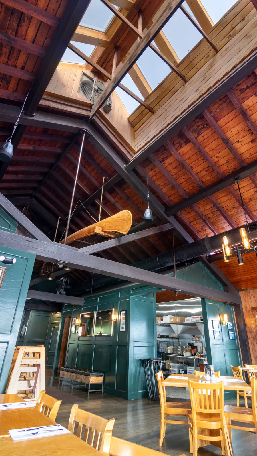 The Boathouse Restaurant dining room featuring wood-clad interior "roofs" to blend with timber ceilings. 