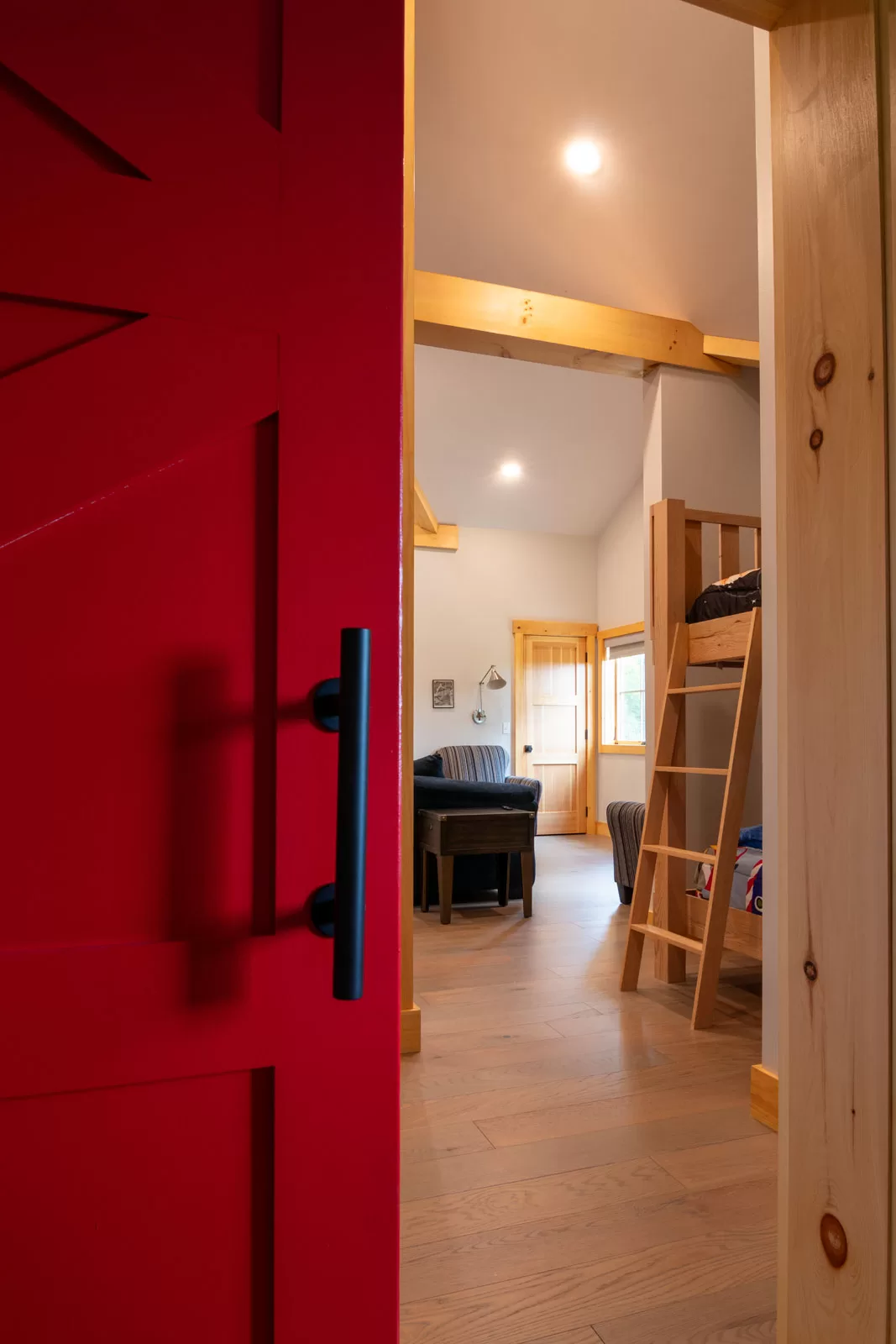 The kids lofted bunk room above the garage with a sliding barn door. 