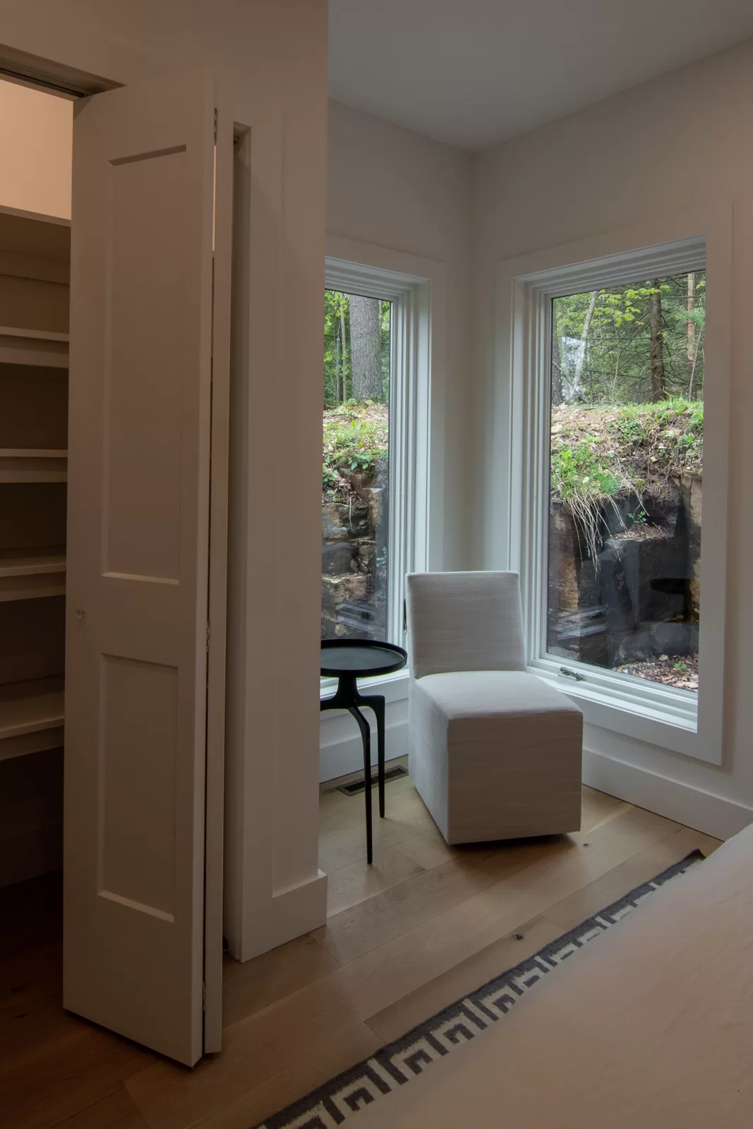 Our Rockview Cabin Primary bedroom features a nook and two large windows in the corner. 