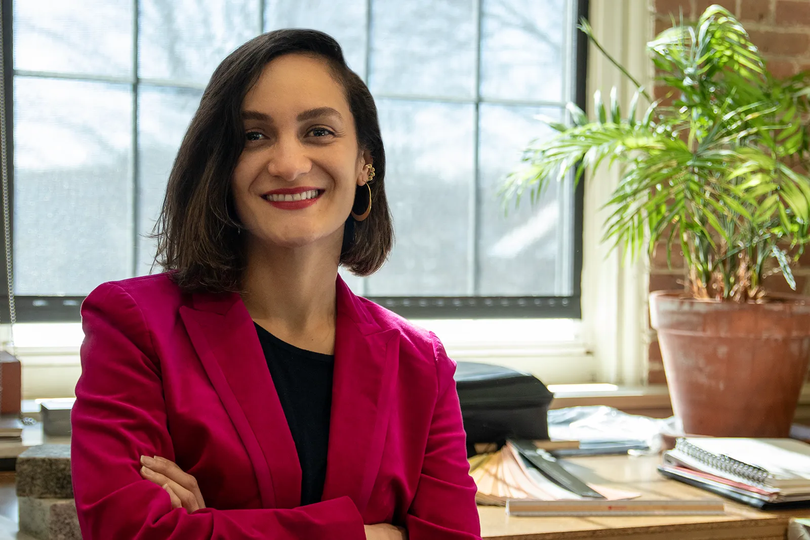 Diana Ayala at her desk as the new Interior Designer for AJA Architecture and Planning. 