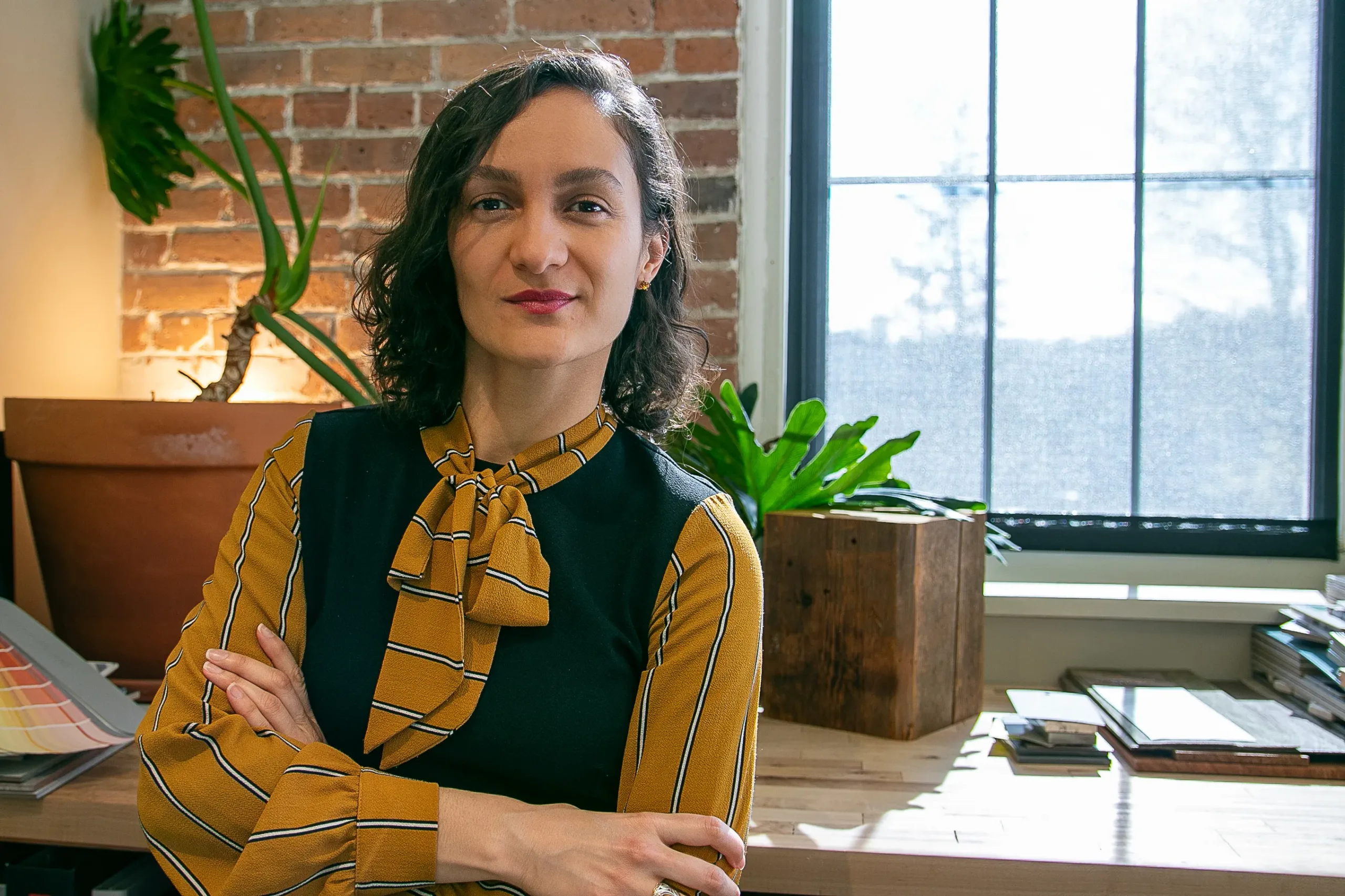 Diana Ayala is the lead interior designer at her desk at AJA Architecture and Planning.